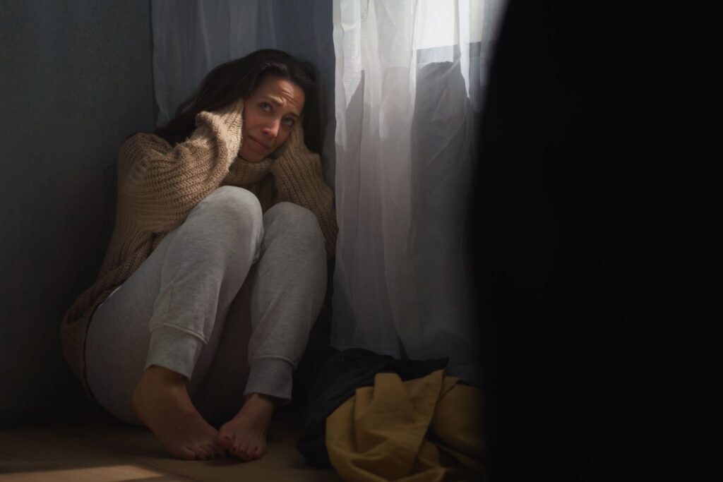scared woman sitting on ground and covering her he 2022 02 10 02 34 57 utc 1