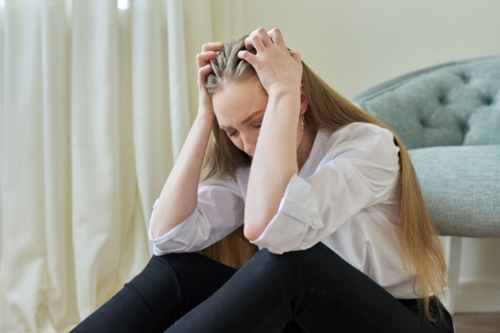 upset crying young woman sitting at home on the fl 2022 02 09 23 24 50 utc
